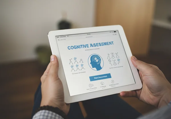 Person starting a cognitive assessment on a tablet device